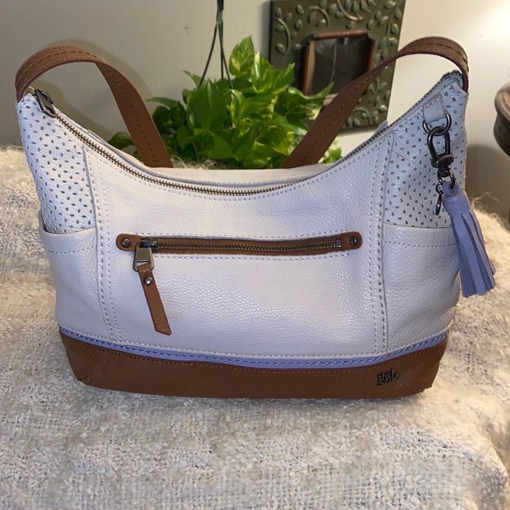 Very clean nice leather cream and tan with gray tassel bag